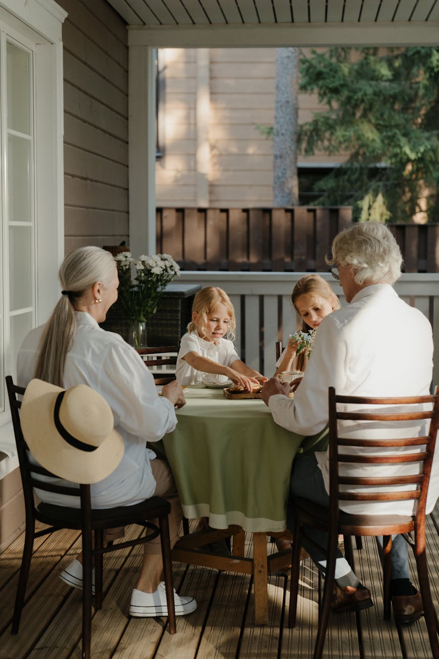 grandparents and children sitting at a table